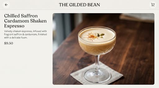 Chilled shaken espresso in a coupe glass with saffron threads and cardamom foam